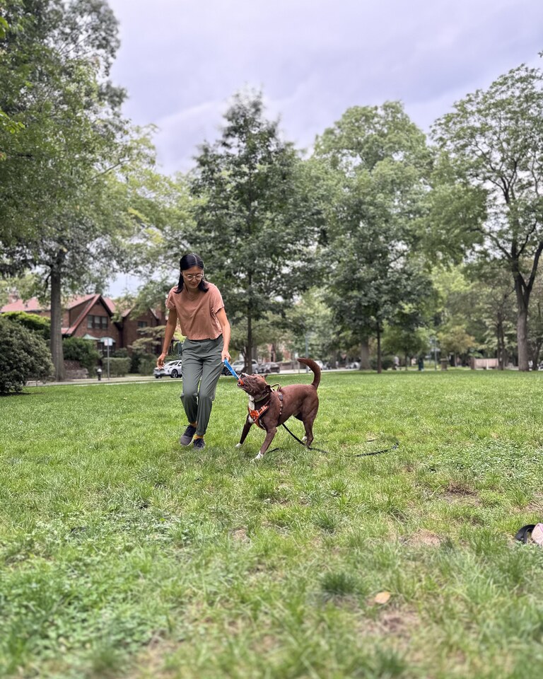 Joyce with a dog on a walk in Queens
